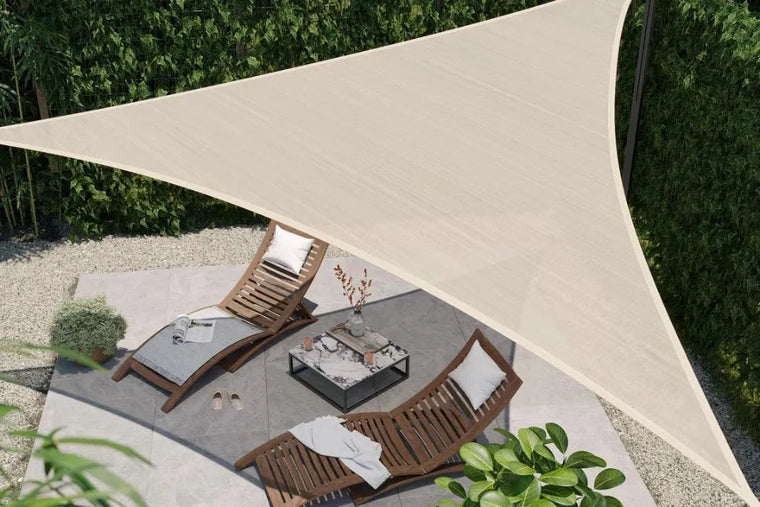 Driehoekig licht schaduwdoek boven ligstoelen op een terras, van bovenaf gezien.
